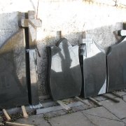 Большой выбор памятников на складе в Киеве. Фигурные памятники из чёрного габбро в ассортименте, после изготовления в цеху.